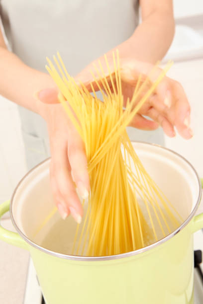 istock Put the pasta into the Pan hand 674251766