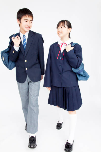 istock Male and female junior high school students walk together 674252160