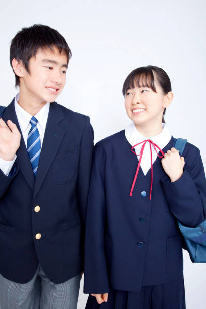 istock Male and female junior high school students walk together 674252170