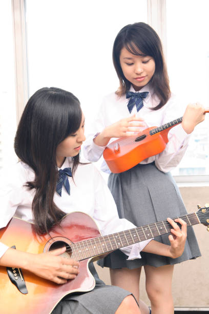 istock High school girls play musical instruments 674252680