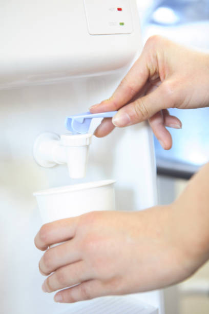 istock Women pumping water at hand 674258186