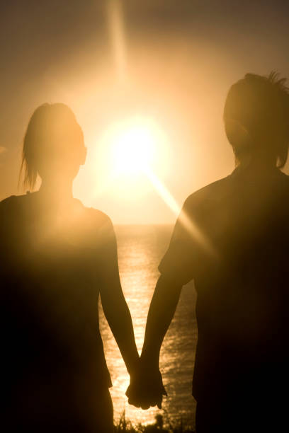 istock Couple tie hand at sunset silhouette 674258648