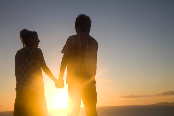 istock Couple tie hand at sunset silhouette 674258814