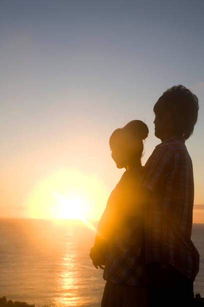 istock Silhouette of a man hug her from behind at dusk 674258920