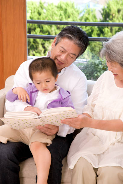 istock An elderly couple grandchildren to read books 674259708