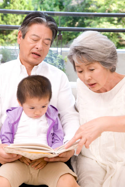 istock Grandmother grandson read the book 674259750