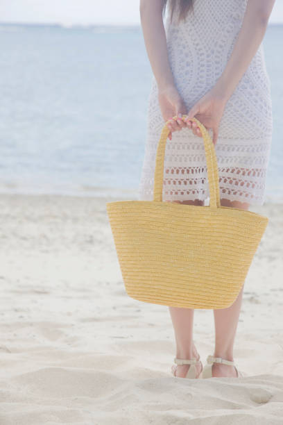istock Back view of a woman standing on the beach 674259870