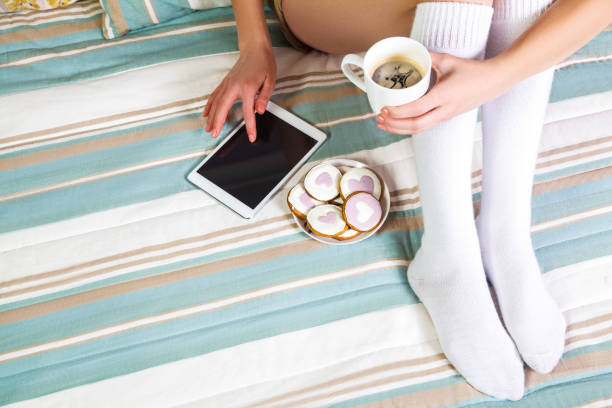 istock Woman using tablet at cozy home atmosphere on the bed. 674260002
