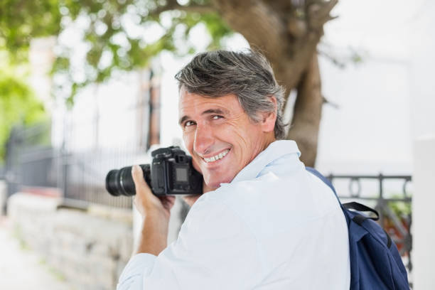 istock Rear view portrait of man using camera 674265378