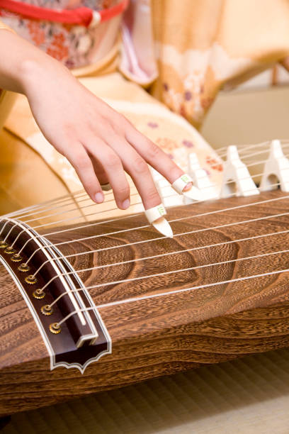 istock Woman playing the harp in hand 674267384
