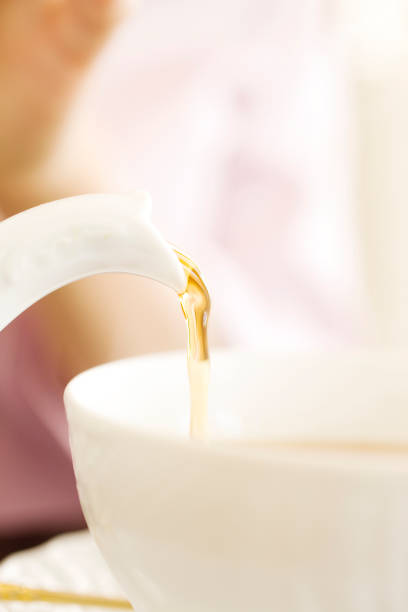 istock Pour the tea into women's hands 674279184