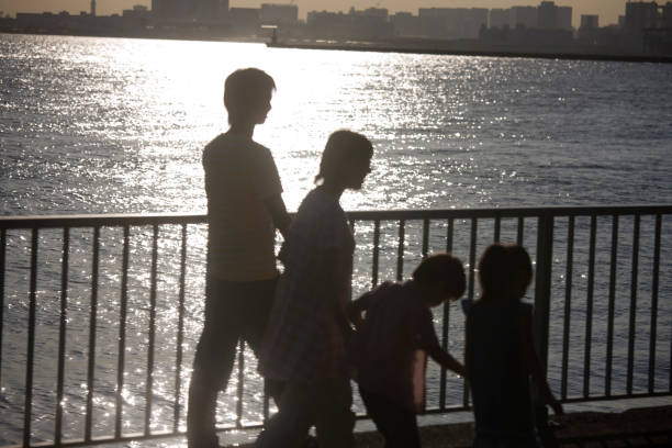 istock Families stroll the river 674288966