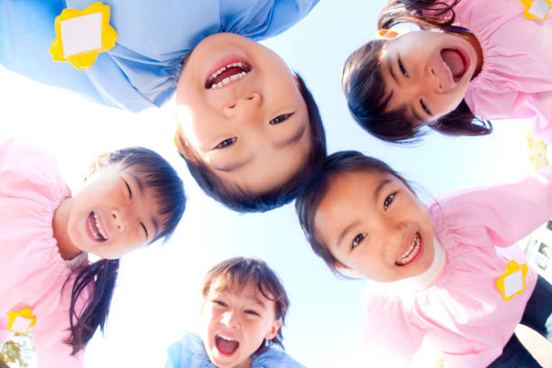 istock Kindergarten children in a circle and laugh at five 674291088