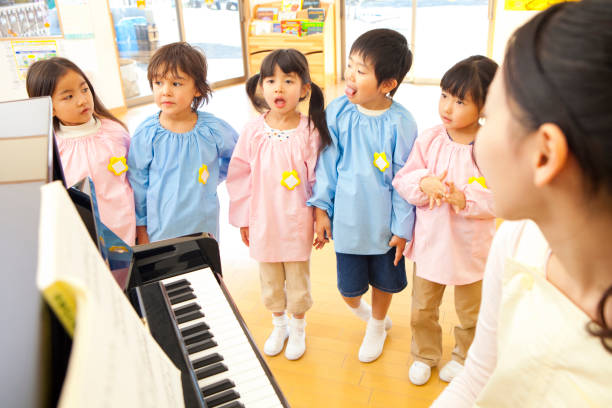 istock Piano teachers in kindergartens in the kindergarten sing along 674291576