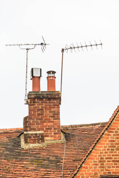 istock Red brick roof with old chimney and antennas 674292016