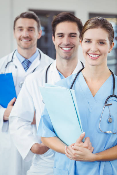 istock Portrait of happy docors standing in row 674298488