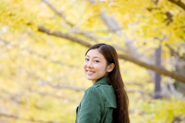 istock Under the Ginkgo tree-lined walk women 674299716