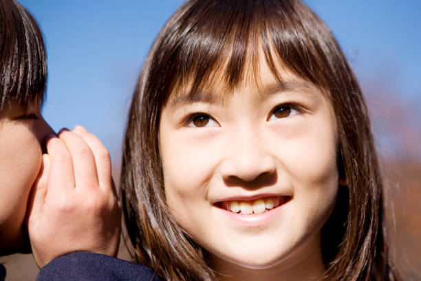 istock I whisper to my friends young daughter 674303428