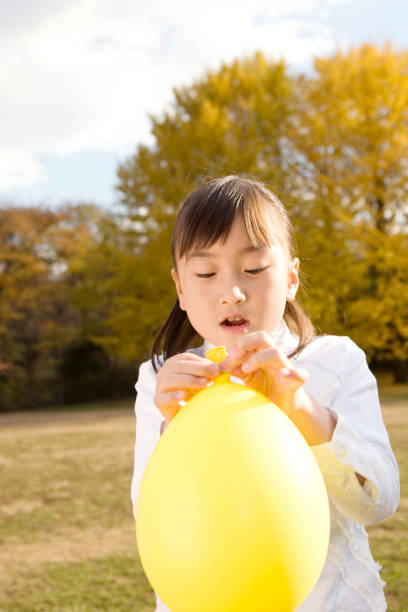 istock Elementary school children playing with balloons 674307906