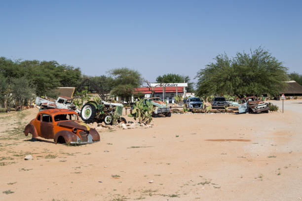 istock Old Timer Car Wrecks in a Desert Landscape in Solitaire, Namibia 674308384