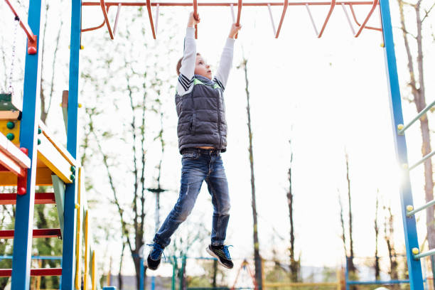 istock Little boy play on playground with blur park background 674318720