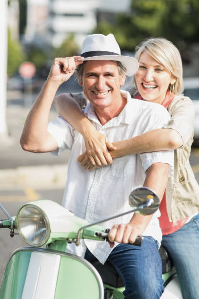 istock Smiling couple sitting motor scooter 674318970