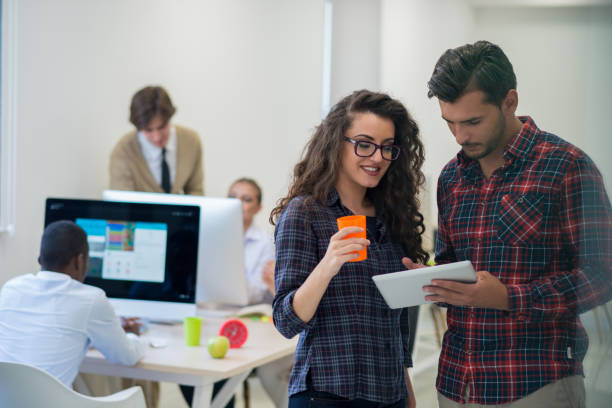 istock young startup business people, couple working on tablet computer 674327934