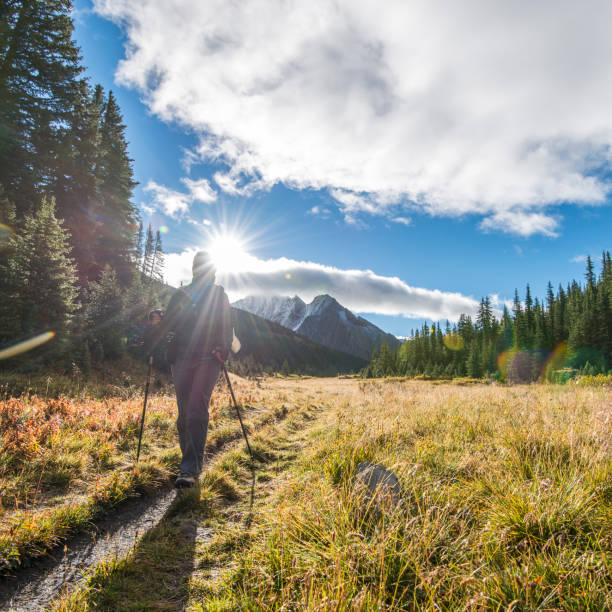 istock Woman hikes along trail in mountains 674330191