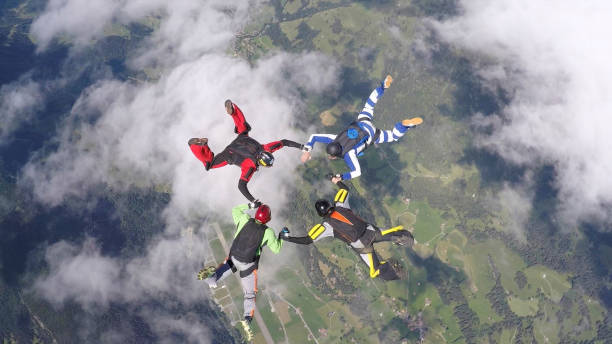 istock POV of skydivers in freefall, over rural landscape 674330201