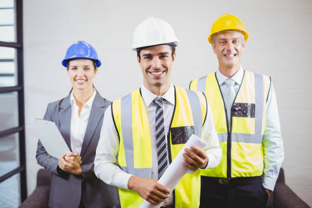 istock Portrait of smiling architects with blueprint 674338794
