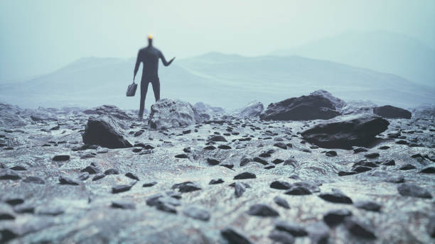 istock Surreal figure walking across the rocky landscape 674344732