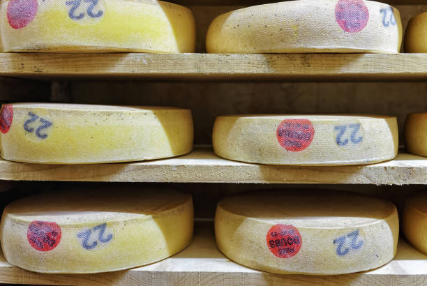 istock Rack of aging Comte Cheese in ripening cellar Franche Comte 674349384