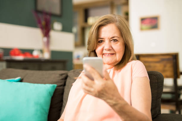 istock Elder woman holding her phone 674351550