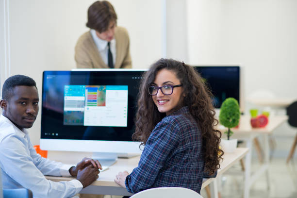 istock Multiethnic group of happy business people working with laptop computer in office 674352010