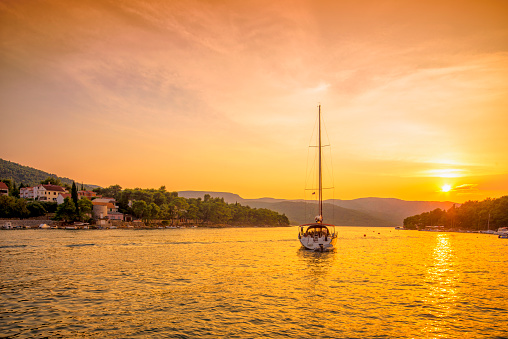 Boat sailing in to the sunset in Stari Grad, Hvar (Croatia)