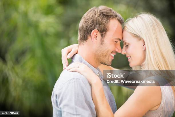 Smiling Couple Hugging Stock Photo - Download Image Now - 30-34 Years, 30-39 Years, 35-39 Years