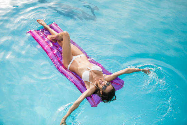 istock Young woman swimming with inflatable raft 674378414
