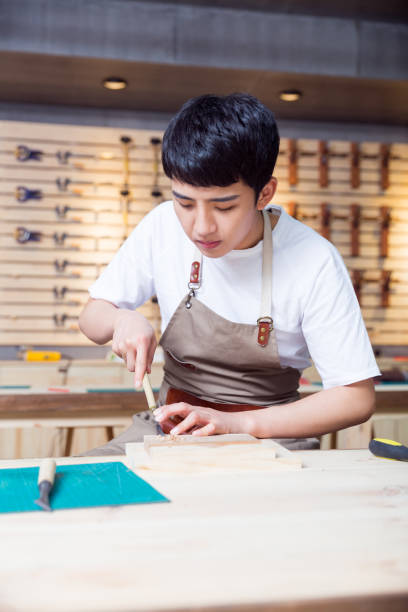 istock portrait of young man working in a carving workshop 674387596