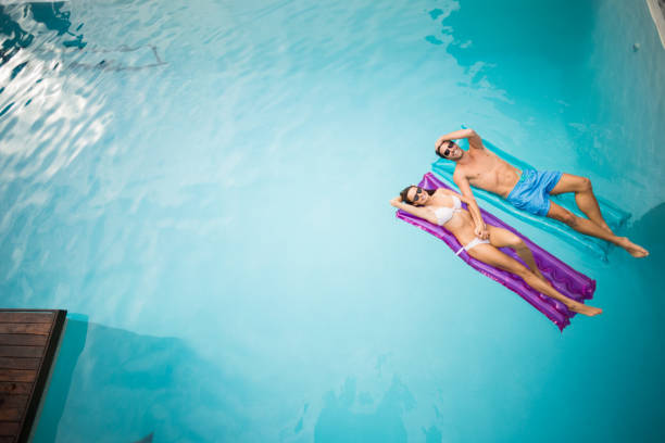 istock Young couple relaxing on inflatable raft 674387686
