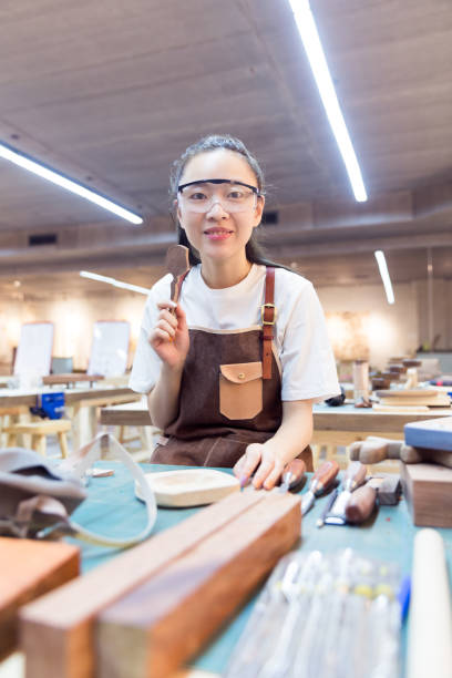 istock portrait of young woman working in a carving workshop 674387724