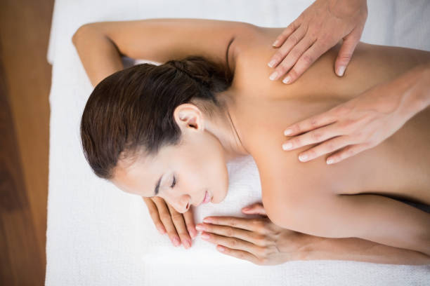 istock Beautiful woman receiving back massage 674388206