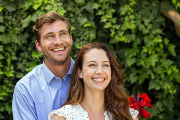 istock Front view of happy couple at front yard 674388292