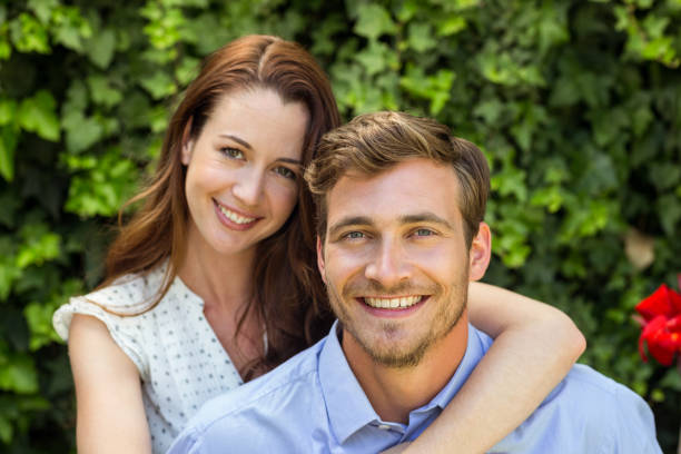 istock Portrait of happy couple at front yard 674388300