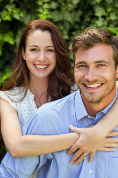 istock Young woman hugging man at front yard 674388322