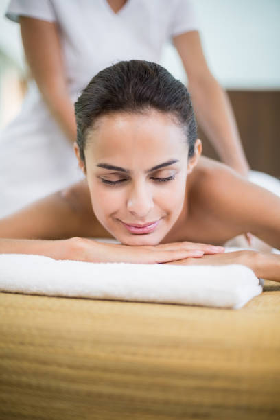 istock Woman with eyes closed while receiving massage 674394198