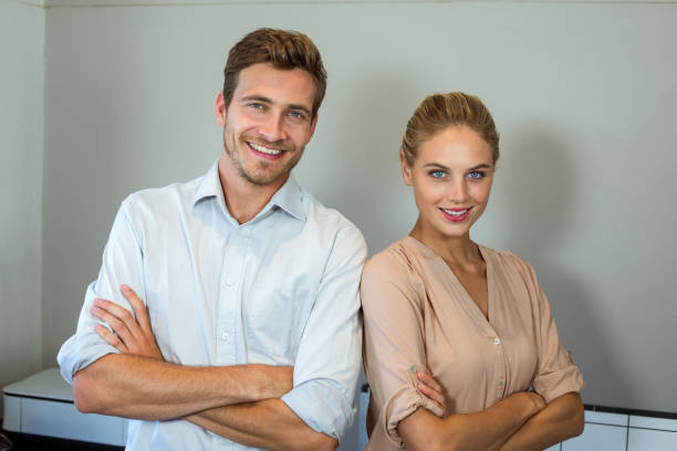 istock Happy man and woman standing at office 674396766