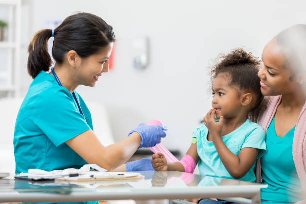 istock Pediatrician wraps young patient's arm 674397500