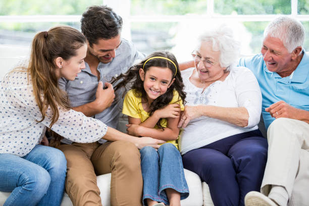 istock Smiling multi-generation family sitting on sofa 674400682