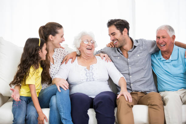 istock Smiling family with grandparents discussing 674400710