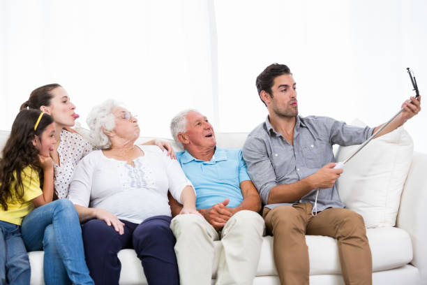 istock Happy family taking self portrait while sitting on sofa 674400736